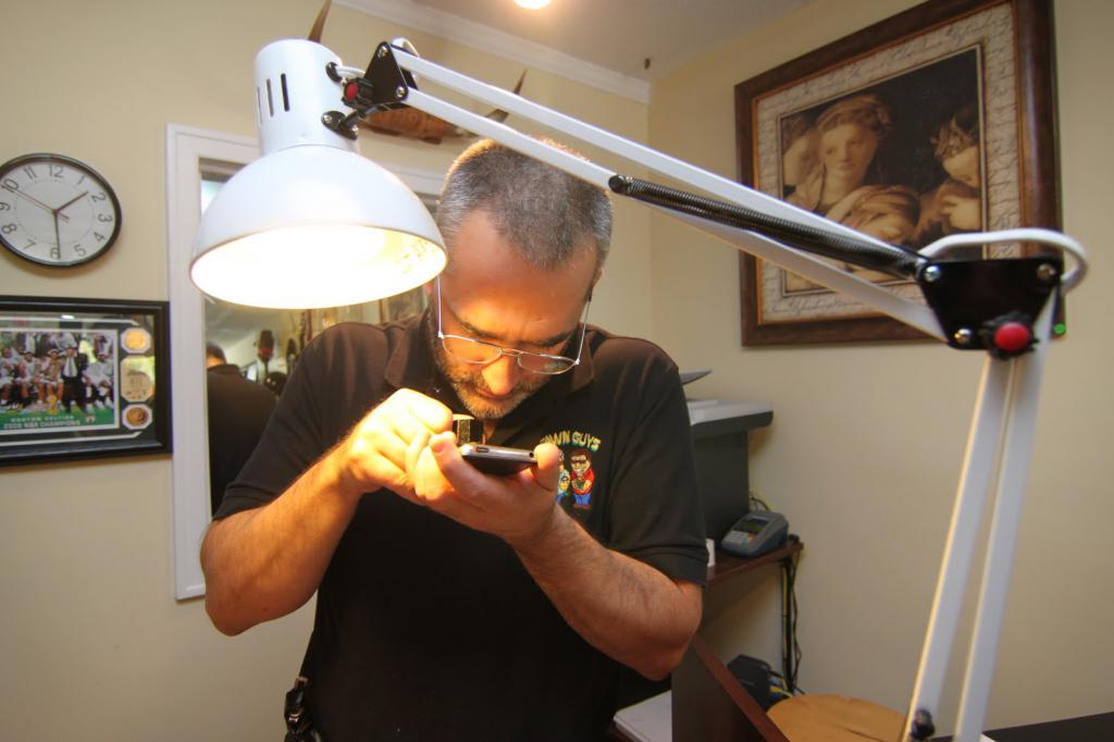 Appraiser closely examines a piece of jewelry