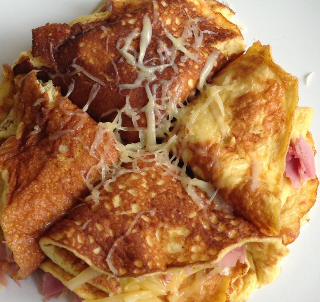 Pancakes with cheese and ham, folded triangle