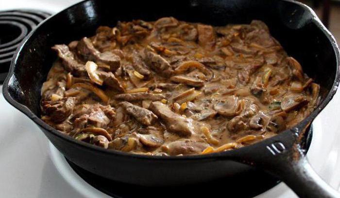 roast pork with mushrooms in the pan