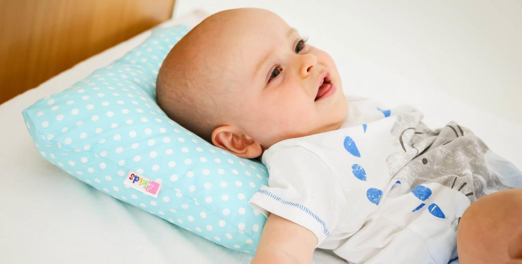 Pillow for the baby on the bed