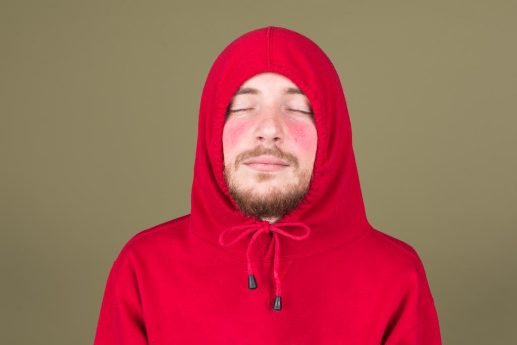 Man with red cheeks in the red sweater