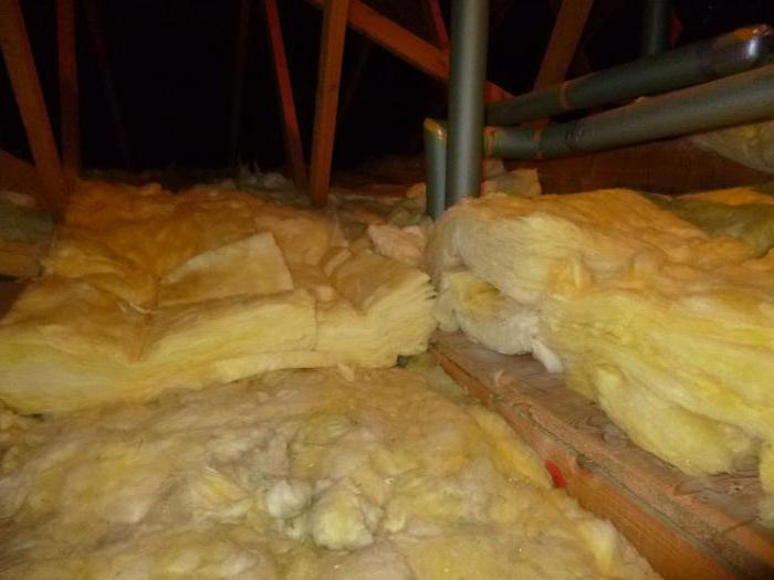 insulation attic in a private house with his hands photo