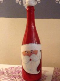 Santa Claus with his hands from the bottle